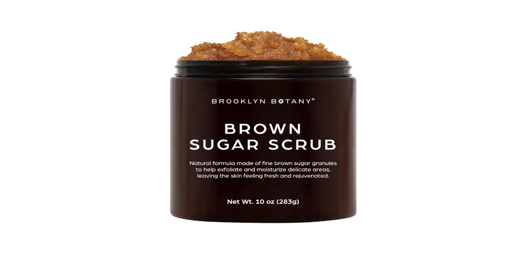 A close-up of the Brooklyn Botany Brown Sugar Body Scrub texture alongside fresh ingredients