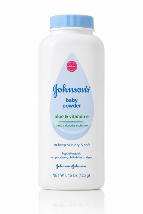 Parent using Johnson's Baby Powder during baby skincare routine