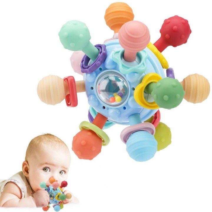 infant holding silicone baby teether during teething stage