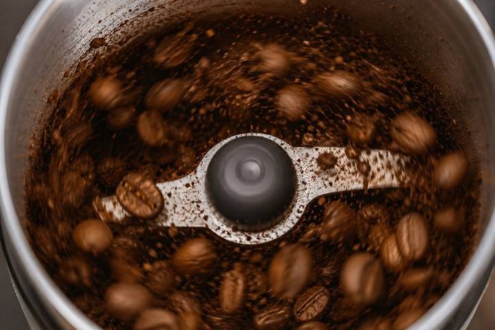 Fresh coffee beans inside Amazon Basics electric grinder