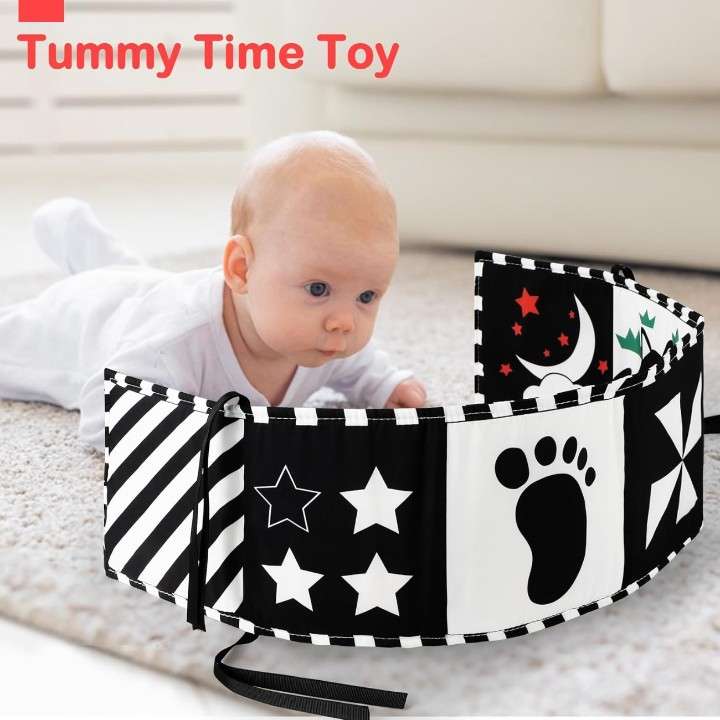 baby using high contrast sensory book during tummy time