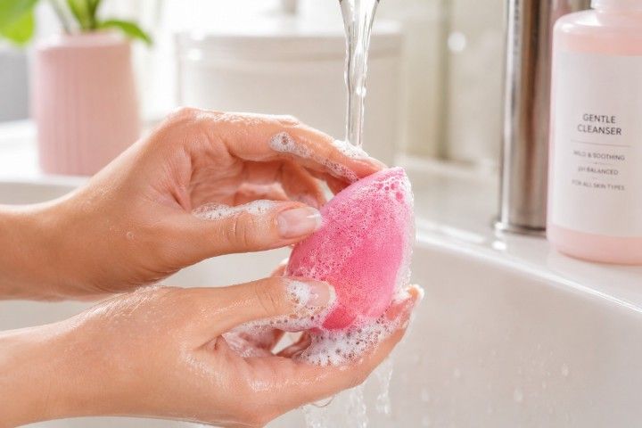Washing a reusable latex-free makeup sponge with gentle cleanser